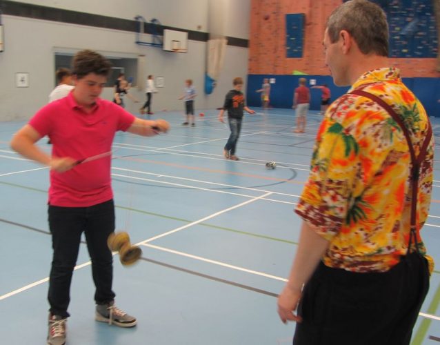 Tom TK Arts teaches diabolo trick at secondary school circus day